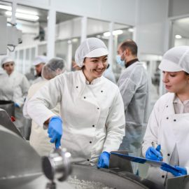 Smiling Female Workers Preparing Necessary Cottage Chees Mixture In Factory For Stuffed Peppers zeitarbeit produktion